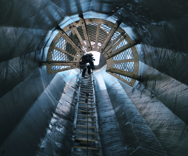 Pinnacle Career Institute wind turbine technician student climbing the interior of the monopole at PCI's outdoor climbing lab